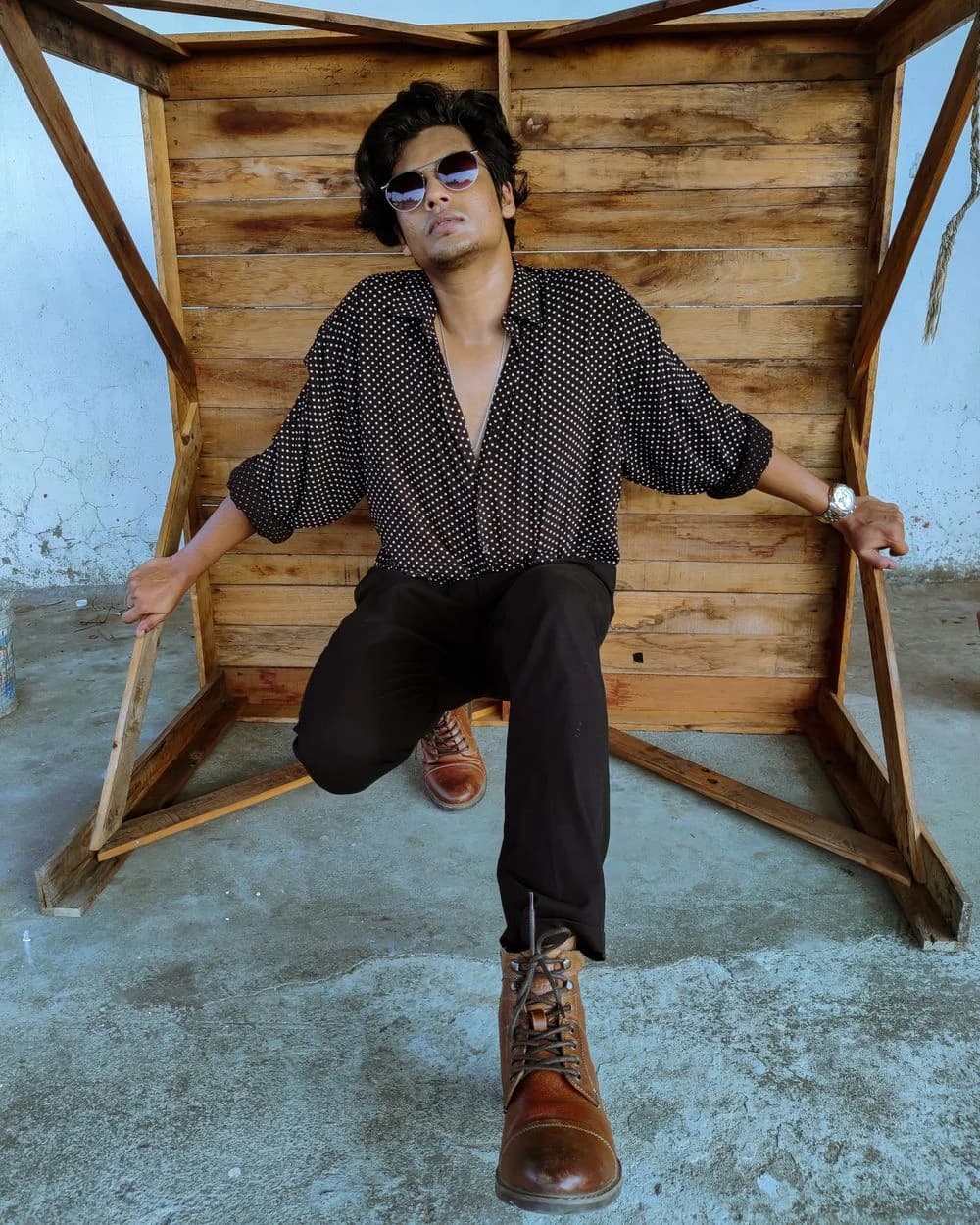 Man in a patterned shirt and boots in a casual fashion portrait