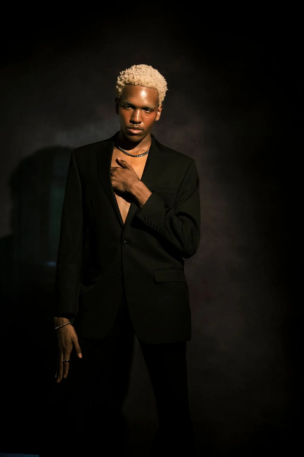 Editorial portrait of a man in a black suit